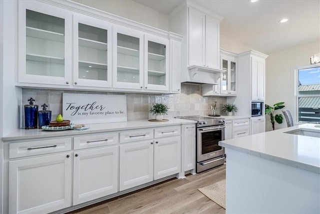 121 Frontside Dr, Corpus Christi, TX 78373 - kitchen featuring high end stainless steel range, white cabinetry, light countertops, backsplash, and recessed lighting