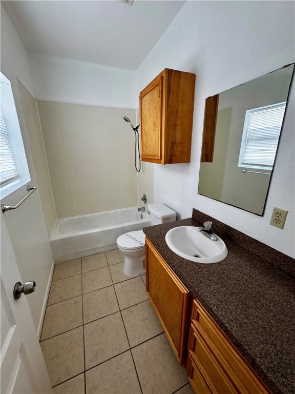 full bathroom featuring toilet, vanity, tile patterned floors, and plenty of natural light