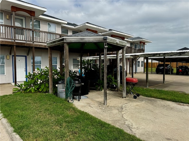 exterior space featuring a lawn and a carport