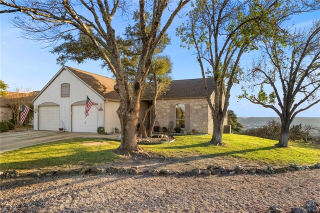 1044 Edinburgh Dr Unit 1044, Kerrville, TX 78028 - view of front of property featuring stucco siding, a front lawn, driveway, stone siding, and an attached garage