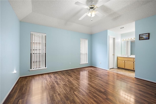 unfurnished bedroom with ceiling fan, wood-type flooring, and a textured ceiling