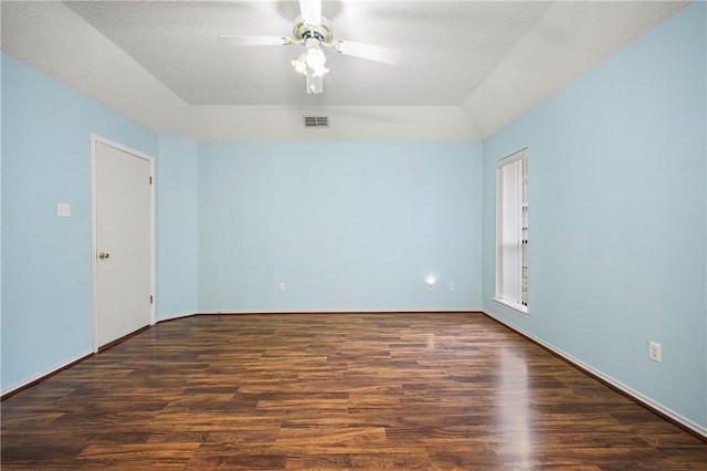 unfurnished room with ceiling fan, dark hardwood / wood-style floors, and a textured ceiling