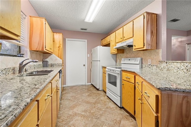 kitchen featuring sink, white appliances, backsplash, light stone counters, and a textured ceiling