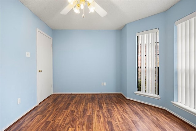 spare room featuring ceiling fan and dark hardwood / wood-style flooring