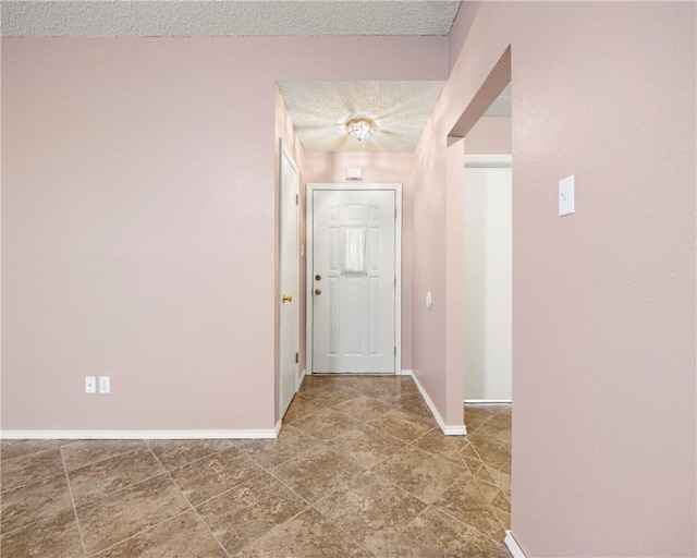 hall with a textured ceiling