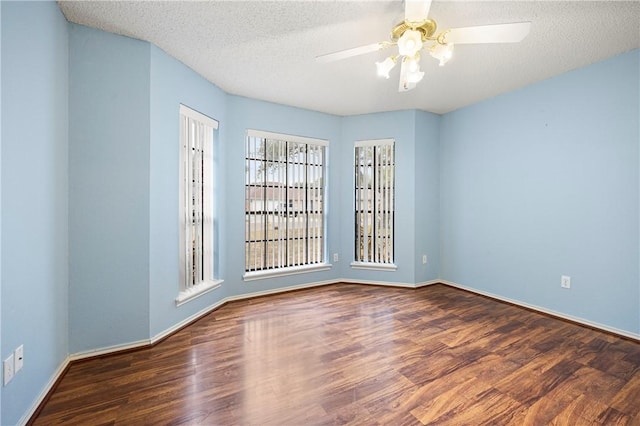 unfurnished room with ceiling fan, dark hardwood / wood-style floors, and a textured ceiling