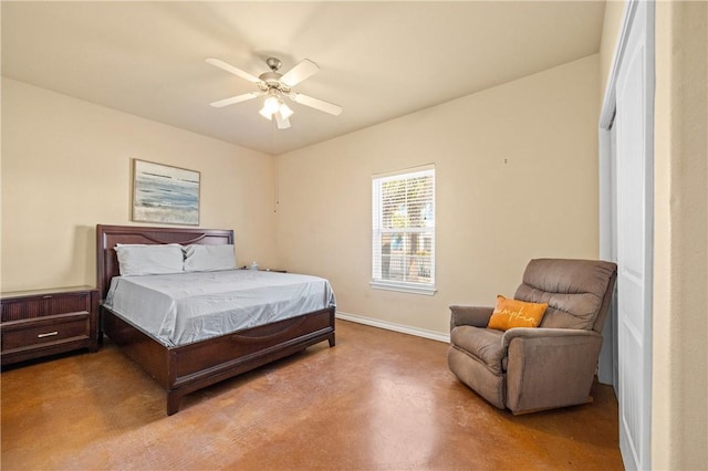 bedroom with a ceiling fan, baseboards, and finished concrete floors