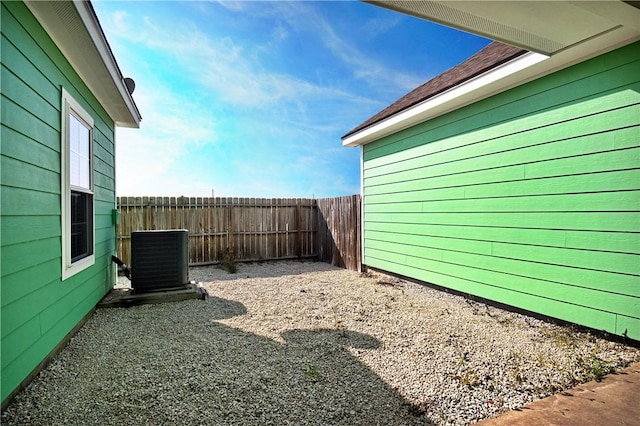 view of yard featuring central air condition unit and a fenced backyard