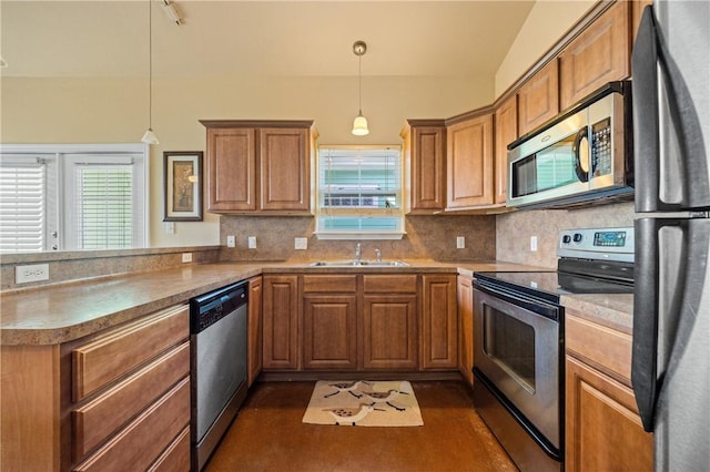 kitchen with backsplash, a peninsula, brown cabinetry, stainless steel appliances, and a sink