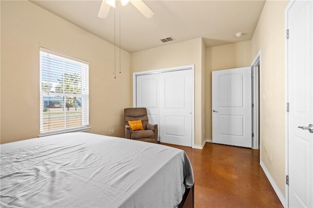 bedroom with visible vents, ceiling fan, baseboards, finished concrete floors, and a closet