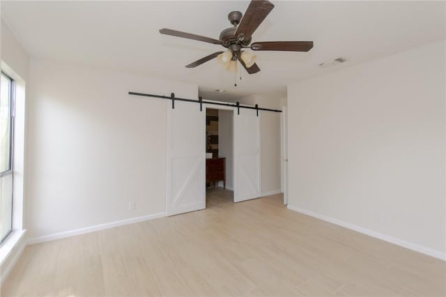 6918 Roseland Dr, Corpus Christi, TX 78414 - unfurnished room with a ceiling fan, light wood-type flooring, and a barn door