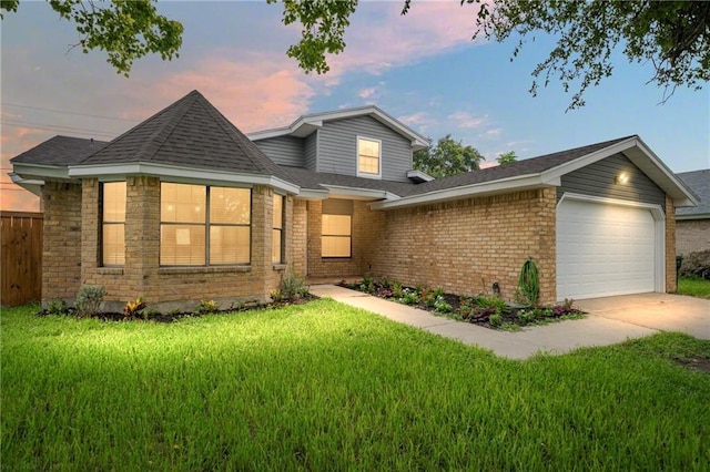 view of front facade with a garage and a yard