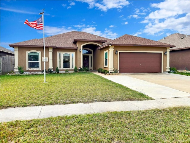 view of front facade with a garage and a front lawn