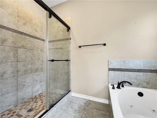 bathroom featuring tile patterned flooring and independent shower and bath