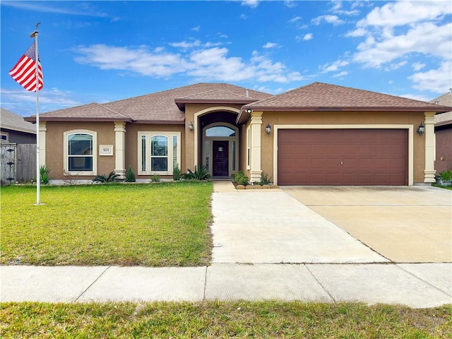 view of front of property with a front lawn and a garage