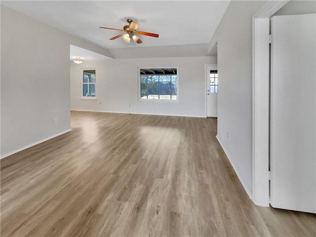 unfurnished living room with ceiling fan and light hardwood / wood-style flooring