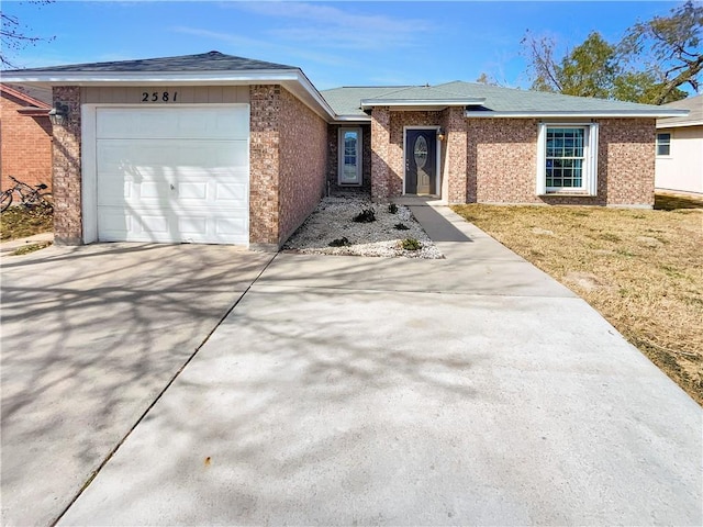 ranch-style home with a garage and a front lawn