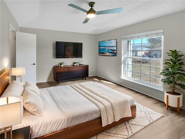 bedroom with ceiling fan and light wood-type flooring