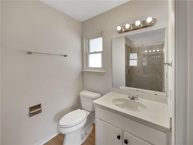 bathroom with an enclosed shower, vanity, and toilet