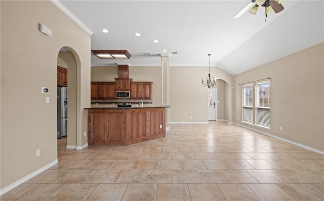 kitchen with ceiling fan with notable chandelier, stainless steel appliances, vaulted ceiling, tasteful backsplash, and ornamental molding