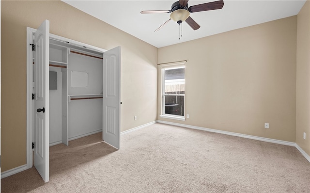 unfurnished bedroom with ceiling fan, a closet, and light colored carpet