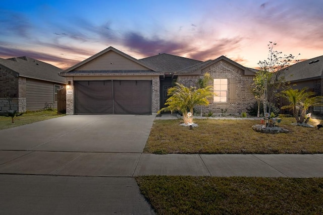 ranch-style home featuring a yard and a garage