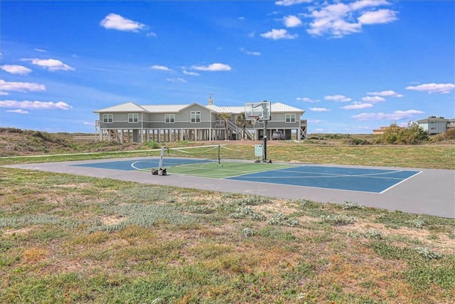 view of sport court with a yard