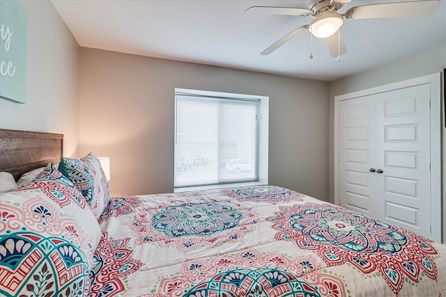 bedroom with ceiling fan and a closet