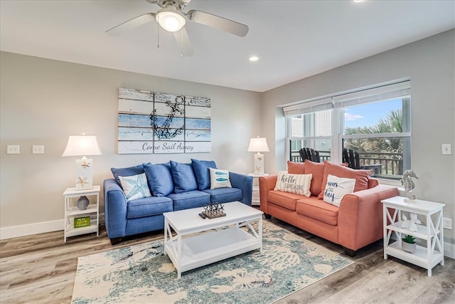 living room with hardwood / wood-style floors and ceiling fan