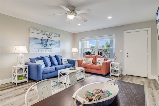 living room featuring light hardwood / wood-style floors and ceiling fan