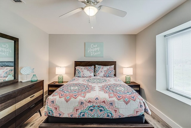 bedroom with hardwood / wood-style floors and ceiling fan