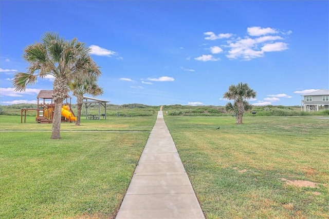 surrounding community featuring a playground and a yard