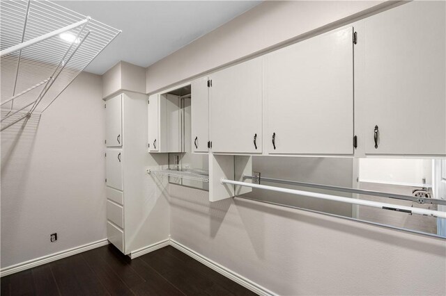 corridor with dark hardwood / wood-style flooring and ornamental molding