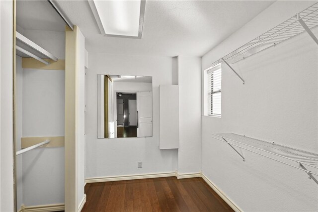 bedroom with ceiling fan, connected bathroom, dark hardwood / wood-style flooring, and crown molding