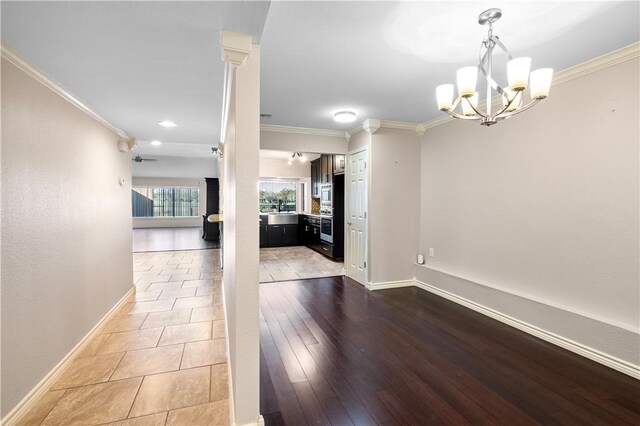 dining area with an inviting chandelier, wood-type flooring, and ornamental molding