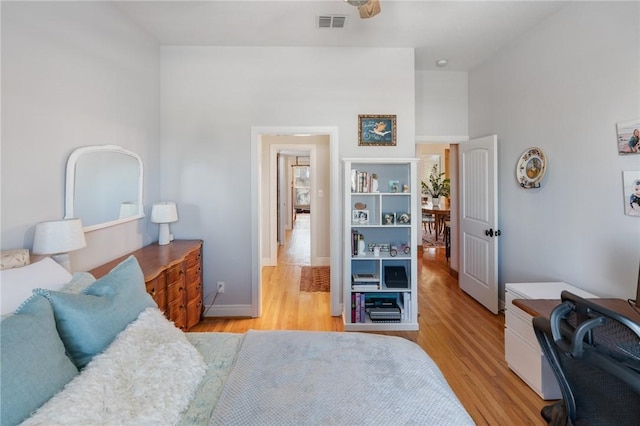 bedroom featuring light wood-style floors, baseboards, and visible vents