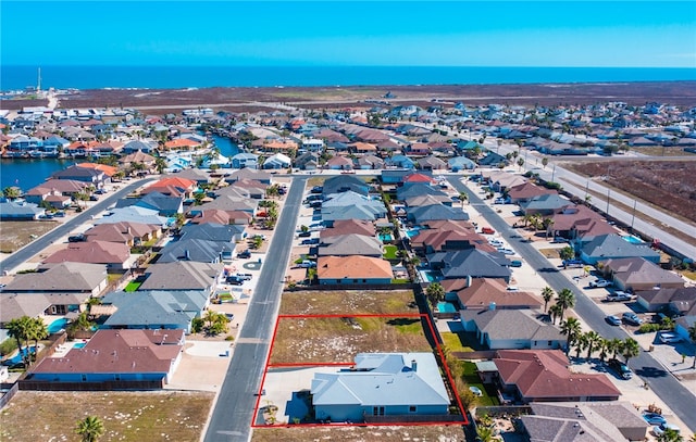 drone / aerial view featuring a water view and a residential view