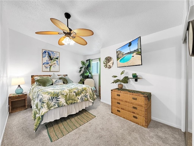 bedroom with baseboards, a textured ceiling, ceiling fan, and carpet