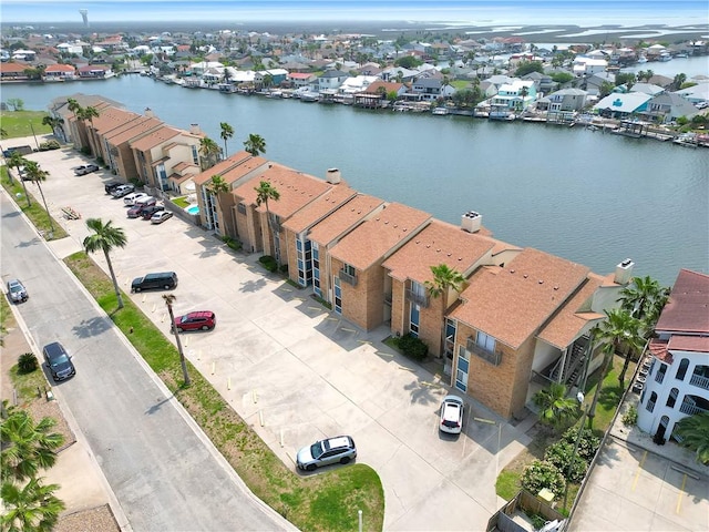 drone / aerial view with a residential view and a water view