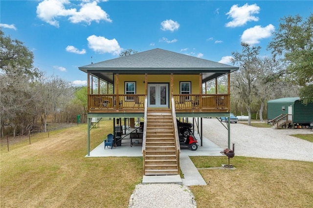 back of house featuring french doors, a patio area, and a lawn