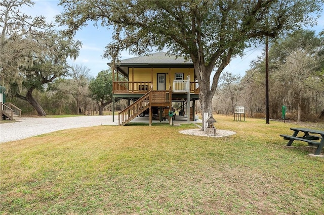 back of property featuring a porch and a yard