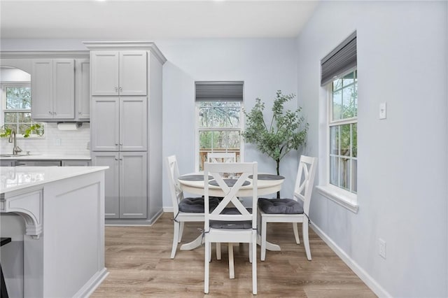 dining room with sink and light hardwood / wood-style floors