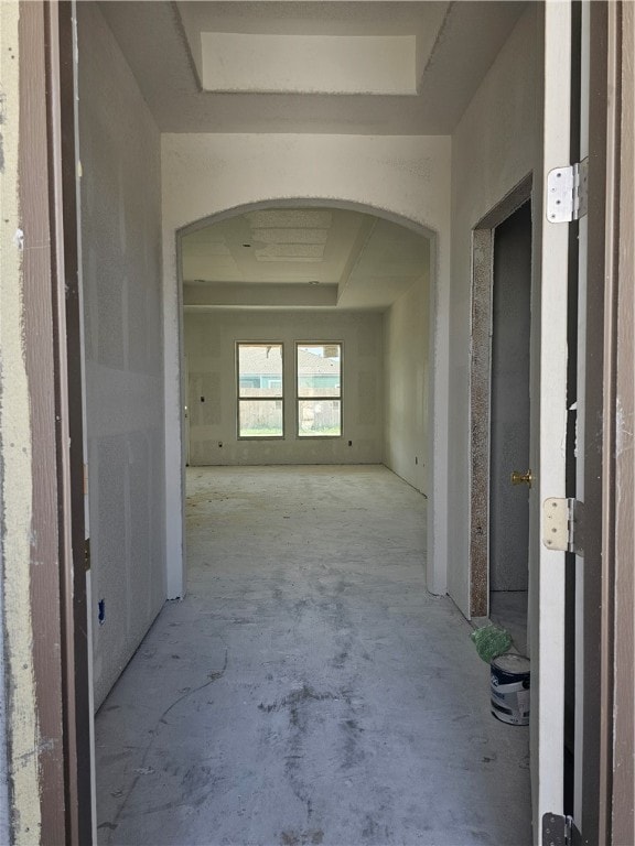 hallway with a raised ceiling