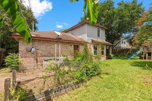 4537 Silver Hollow Dr, Corpus Christi, TX 78413 - back of house featuring a playground, brick siding, a vegetable garden, and roof with shingles
