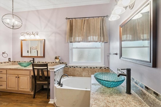 4537 Silver Hollow Dr, Corpus Christi, TX 78413 - bathroom with crown molding, wood finished floors, vanity, a garden tub, and a chandelier