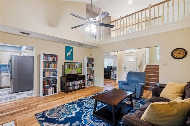 4537 Silver Hollow Dr, Corpus Christi, TX 78413 - living area with light wood-style flooring, stairs, ceiling fan, and a high ceiling