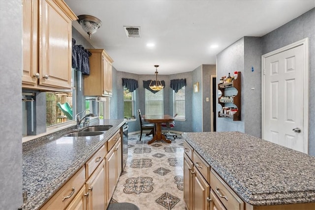 4537 Silver Hollow Dr, Corpus Christi, TX 78413 - kitchen featuring light brown cabinetry, dark stone countertops, pendant lighting, dishwasher, and recessed lighting
