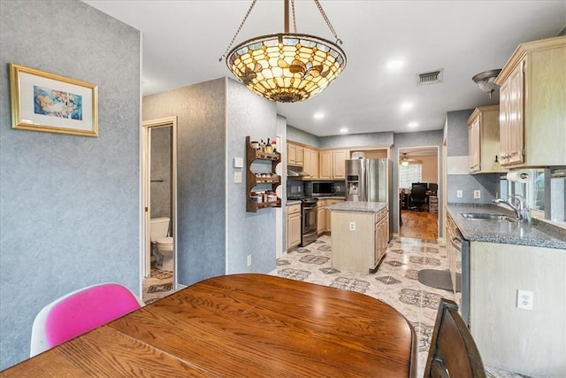 4537 Silver Hollow Dr, Corpus Christi, TX 78413 - kitchen with appliances with stainless steel finishes, a center island, light brown cabinets, a textured wall, and pendant lighting