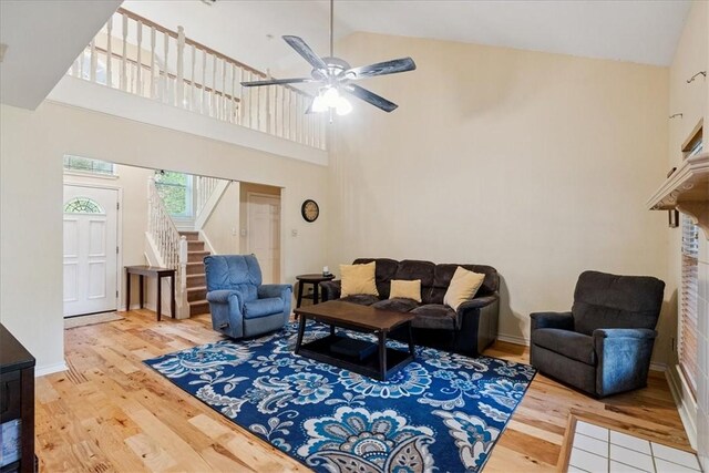 4537 Silver Hollow Dr, Corpus Christi, TX 78413 - living room with wood finished floors, high vaulted ceiling, a ceiling fan, and stairs