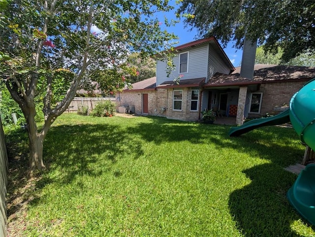 4537 Silver Hollow Dr, Corpus Christi, TX 78413 - rear view of property with a chimney and brick siding